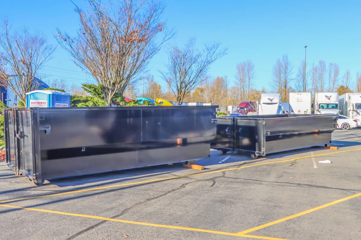 Professional dumpster rental service with roll-off container on residential driveway in Lake Stickney